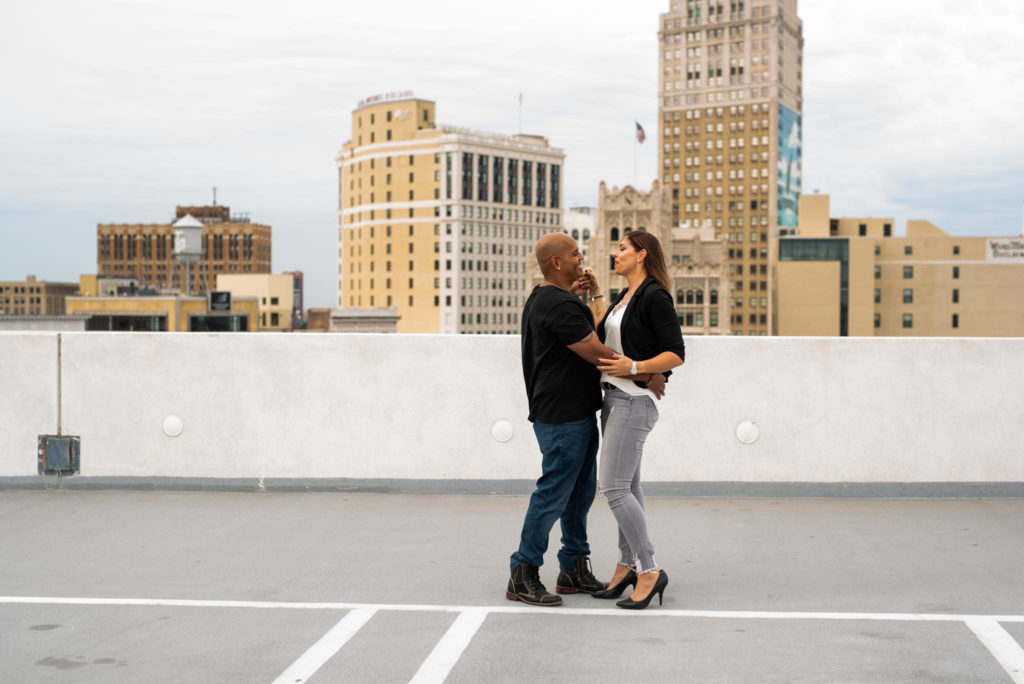 Couple dancing on rooftop downtown Detroit.