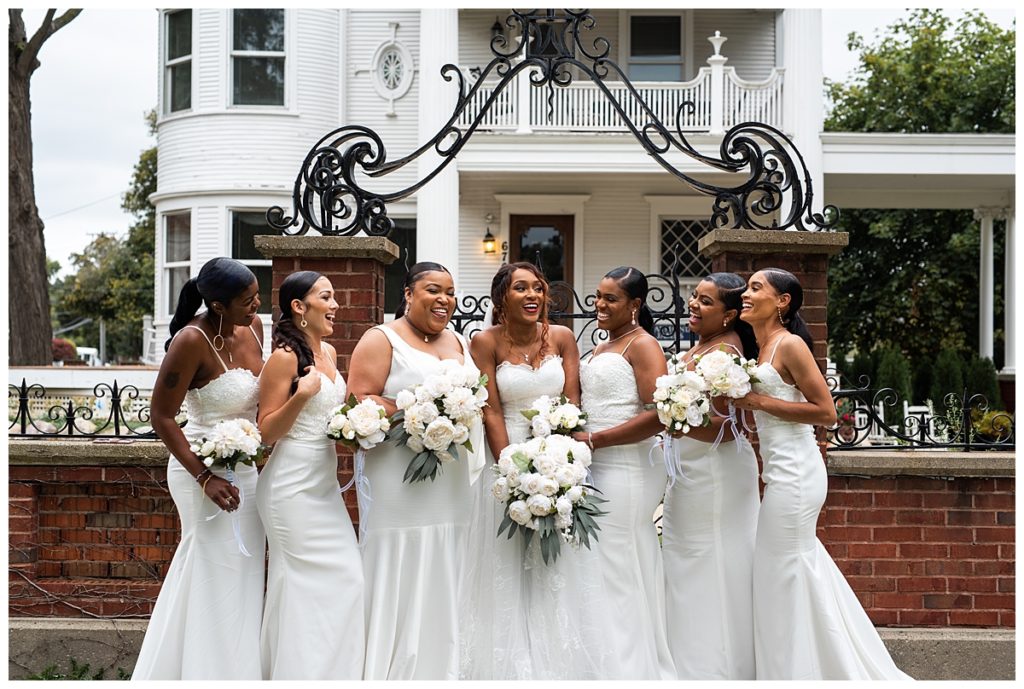 Bridesmaids and Bride Laughing in front of Mansion in Plymouth