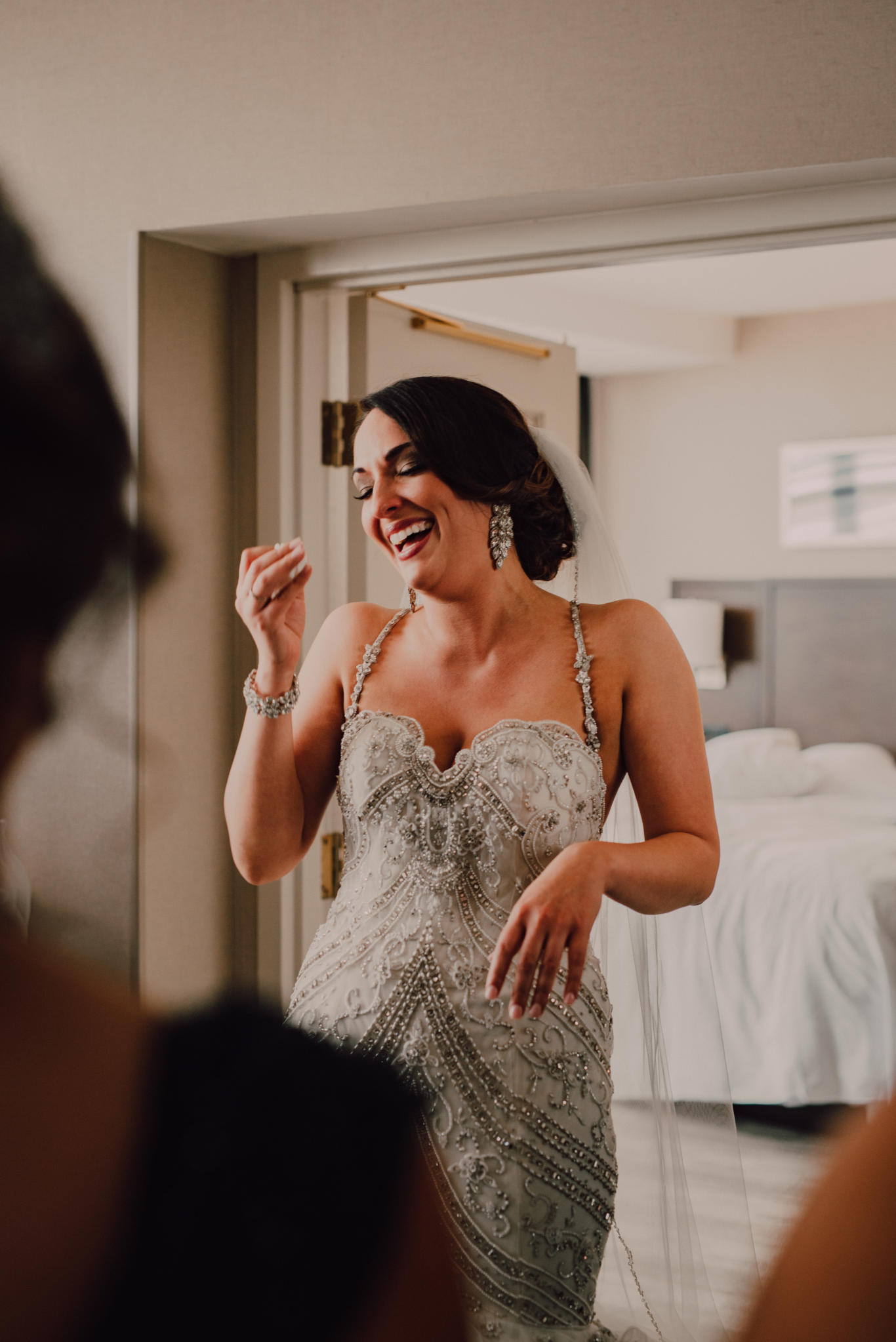 Bride Laughing and crying after her big reveal to the bridesmaids.