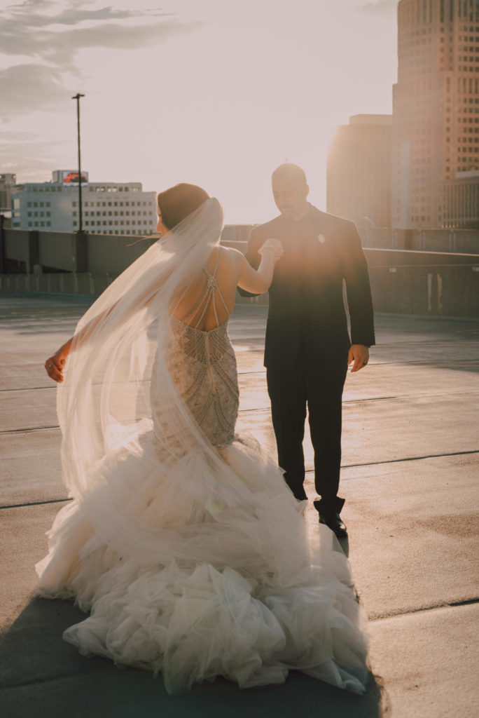 Couple dancing on roof top at sunset.
