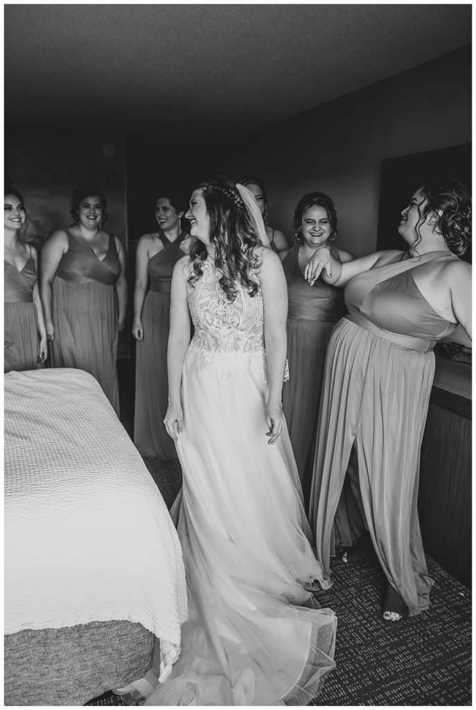 Bride surrounded by Bridesmaids during their getting ready.
