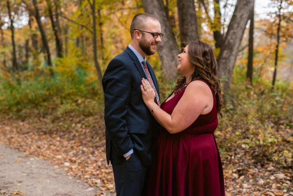 Newly engaged couple look lovingly into eachother's eyes during their engagement session at kensington metropark.