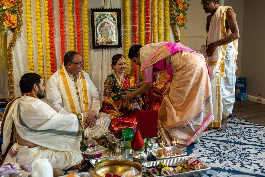 Couple sitting for traditional hindu ceremonies.