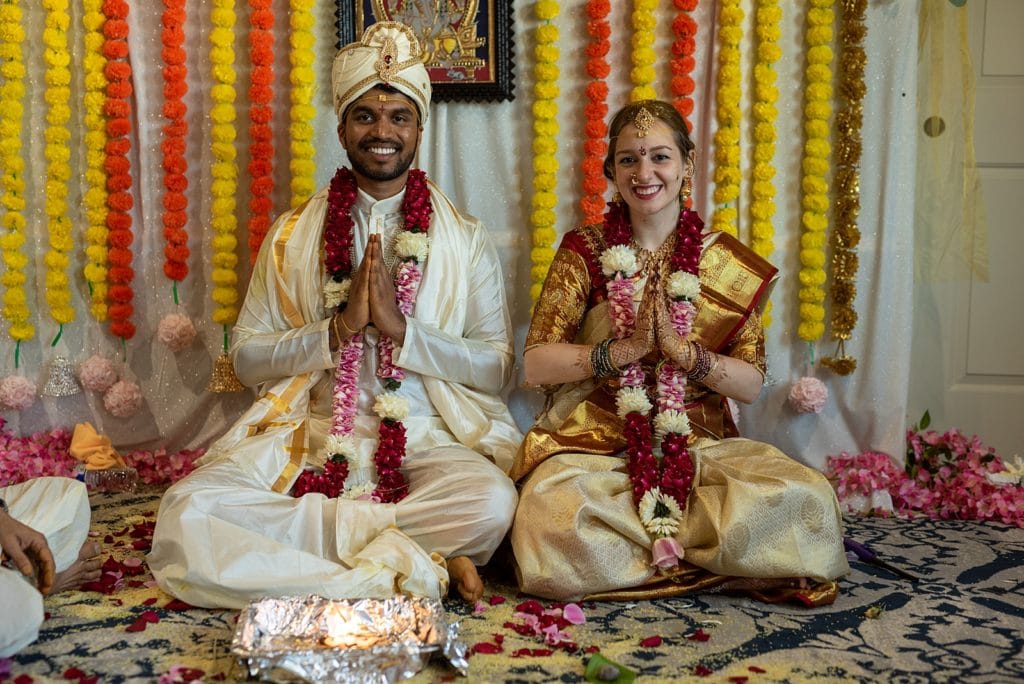 In traditional wear, the Bride and Groom sit for final prayers.