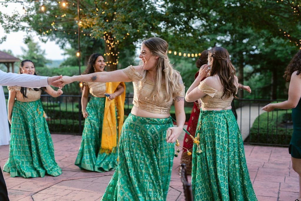 Bridesmaid dancing at wedding reception at Pine Knob Mansion.