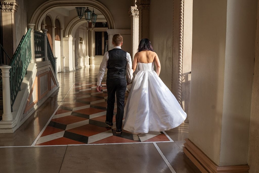 Bride and Groom walking through the Venetian Resort in Las Vegas.
