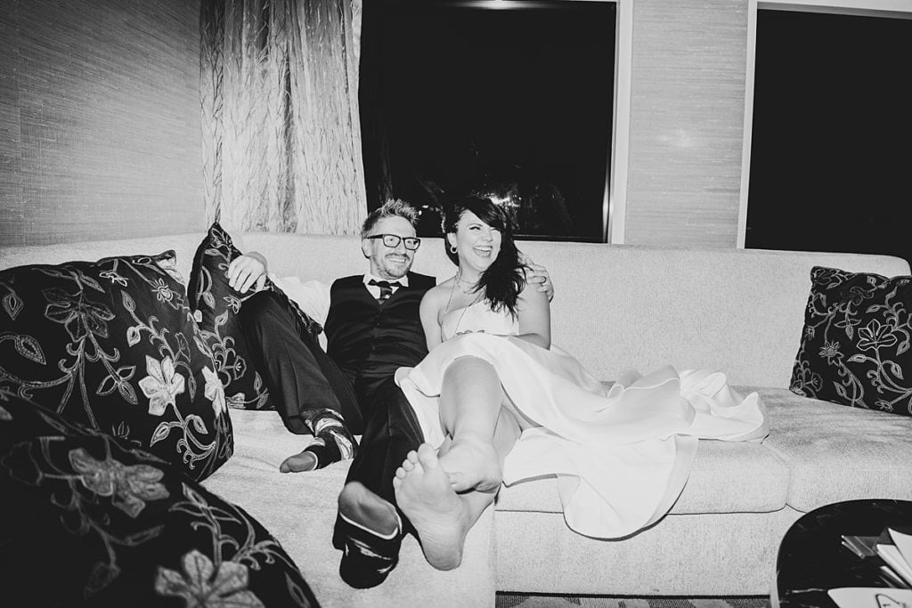 Bride and Groom sitting on the couch in a vintage Vegas vibe.