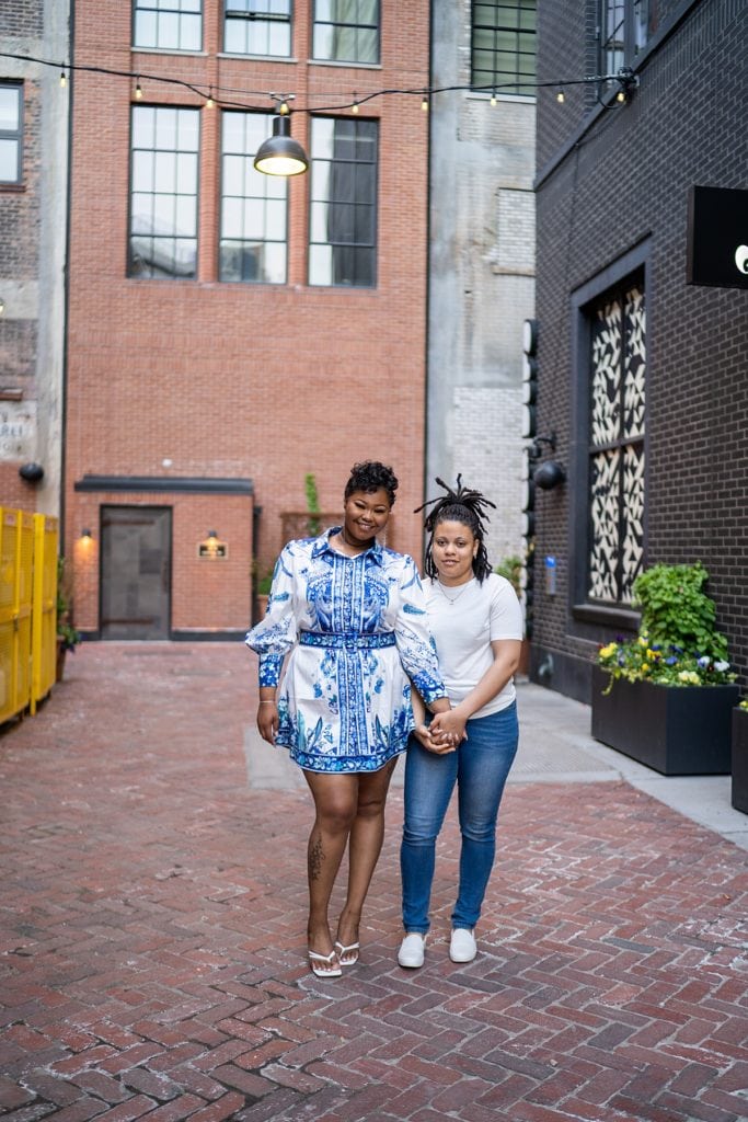 Couple posing in alley in Detroit behind Shinola Hotel for their engagement session..
