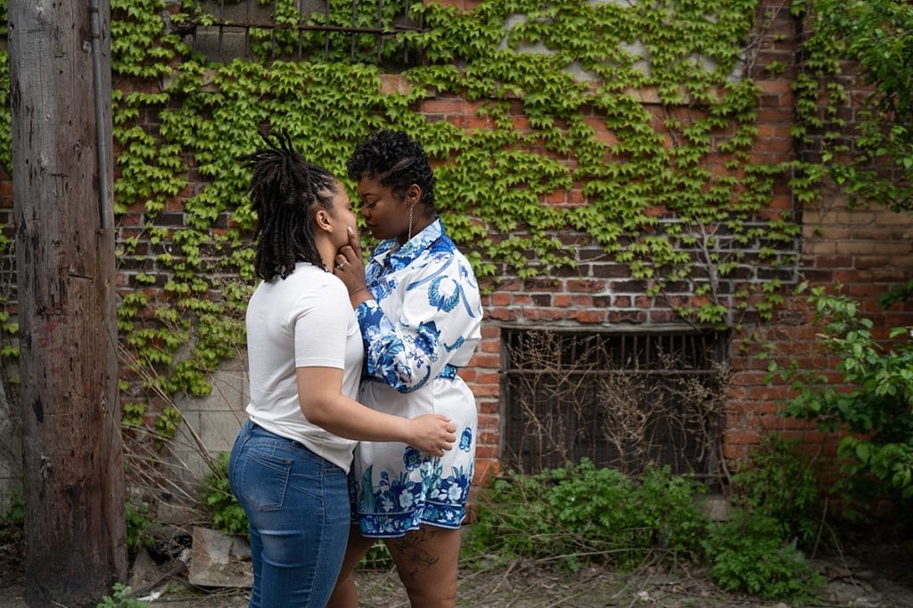 downtown detroit engagment session, couple kissing in the alley in eastern market.