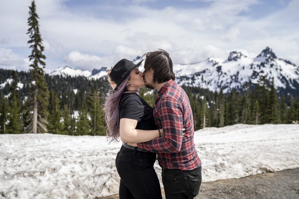 Couple kissing during their engagement session in the mountains, Mt Rainier Washington.