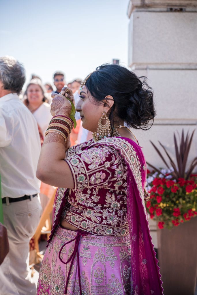Bride walking down the aisle at her indian ceremony outside on the rooftop at the park shelton in Detroit.