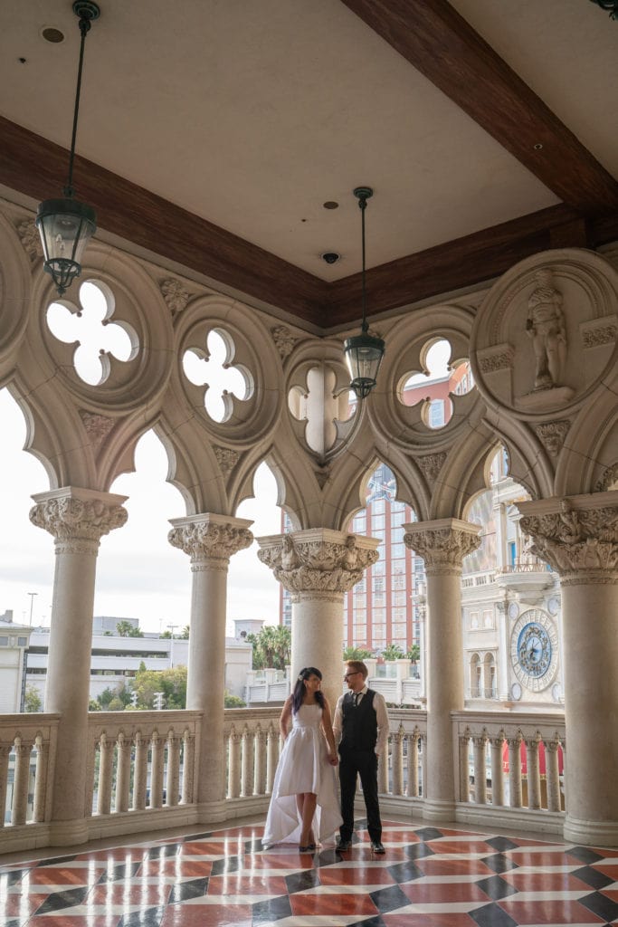 Bride and Groom standing on the porch of the Venetian in Vegas.