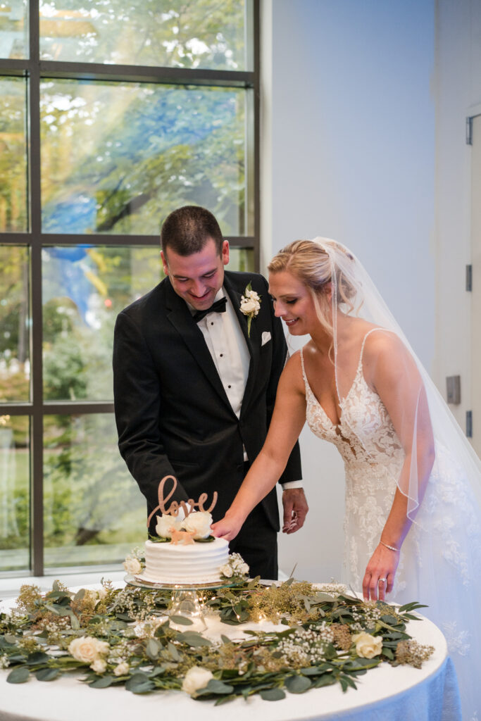 bride and groom cutting their cake on their wedding day