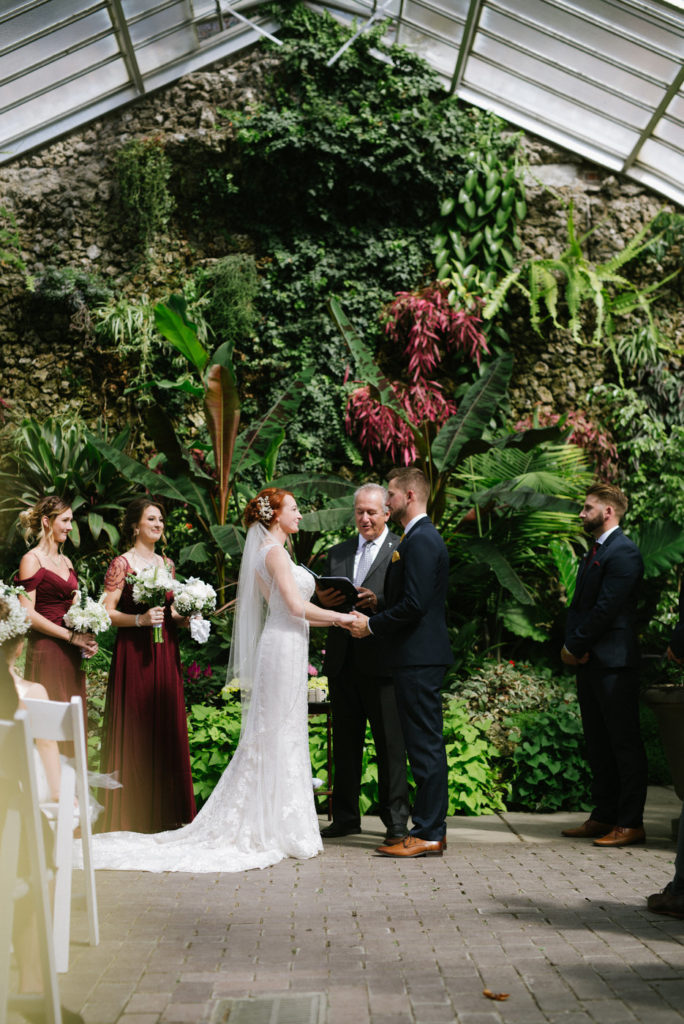 Bride and Groom exchanging vows in a historical Detroit conservatory.