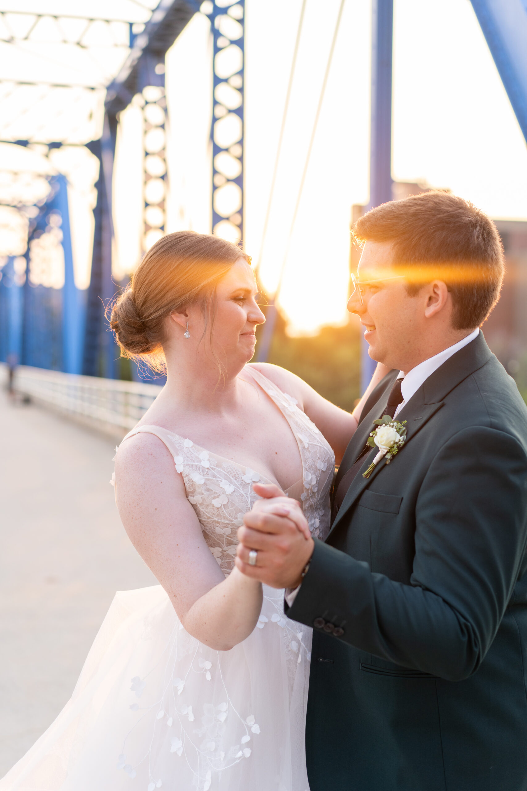 couple standing on the blue bridge in downtown grand rapids