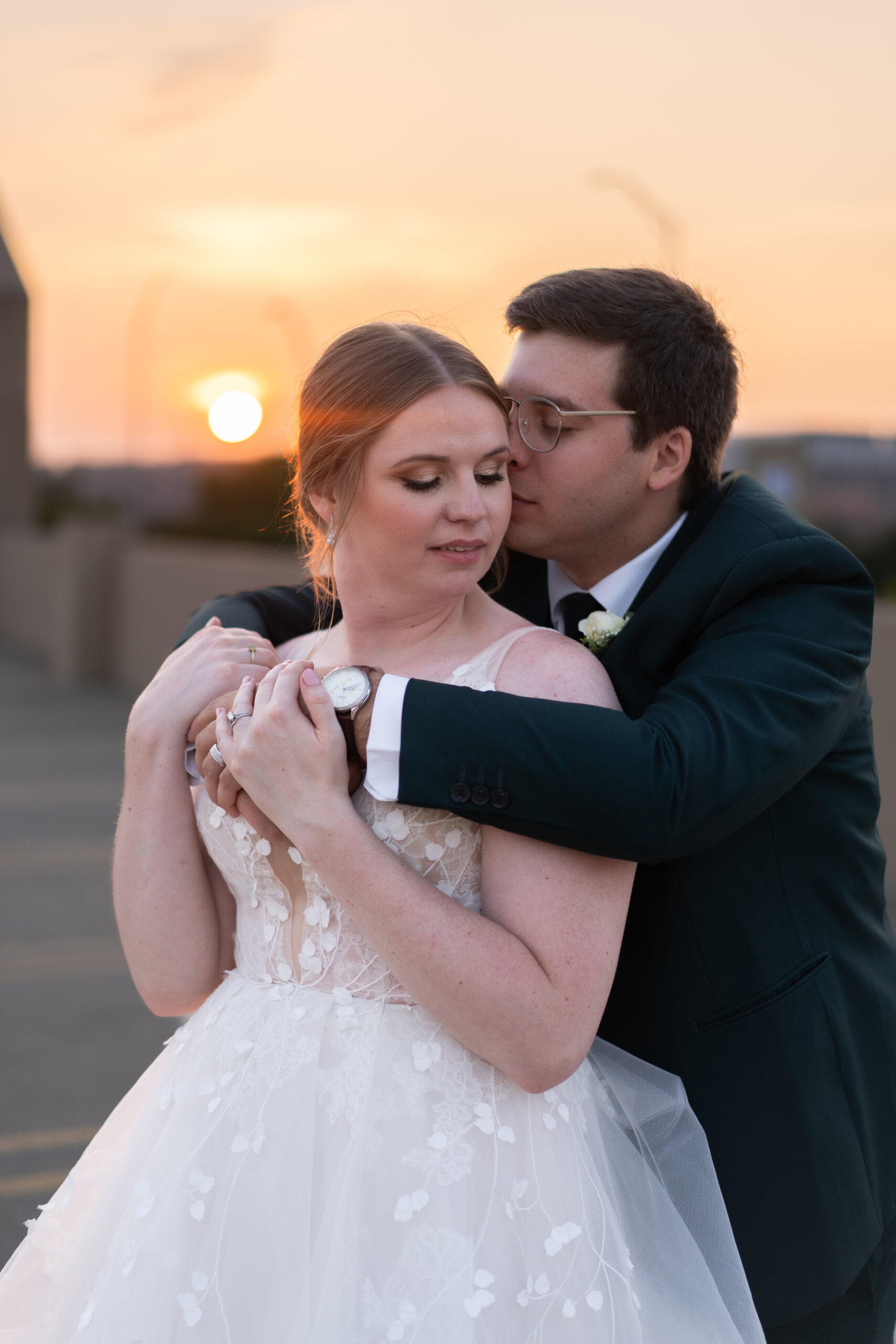 bride and groom hugging on a rooftop in Grand Rapids at Golden Hour