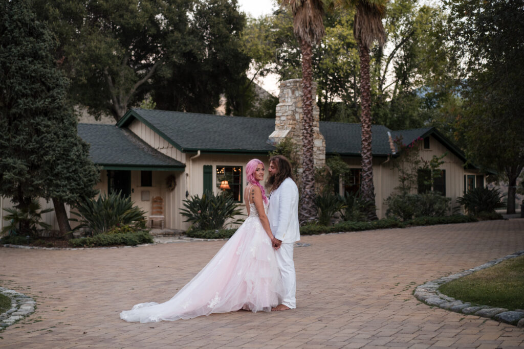 Bride and Groom posing in front of the main house on the Mesa del Sol property.